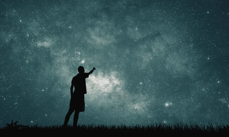 man looking at stars